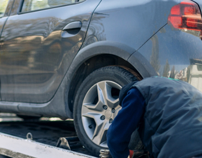A man getting ready to tow a donated vehicle